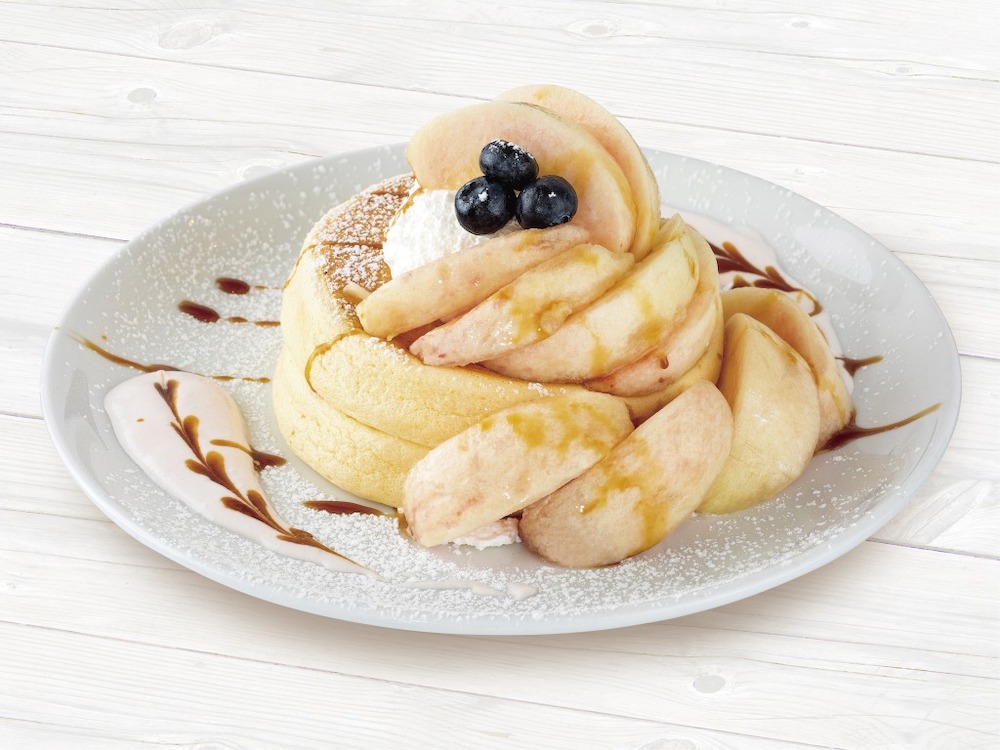 「高倉町珈琲」38店舗は6月30日より、「季節限定の旬果パンケーキシリーズ」第4弾として、山梨県産100％の桃をふんだんに使用した「フレッシュ桃のリコッタパンケーキ」を期間限定で展開する。