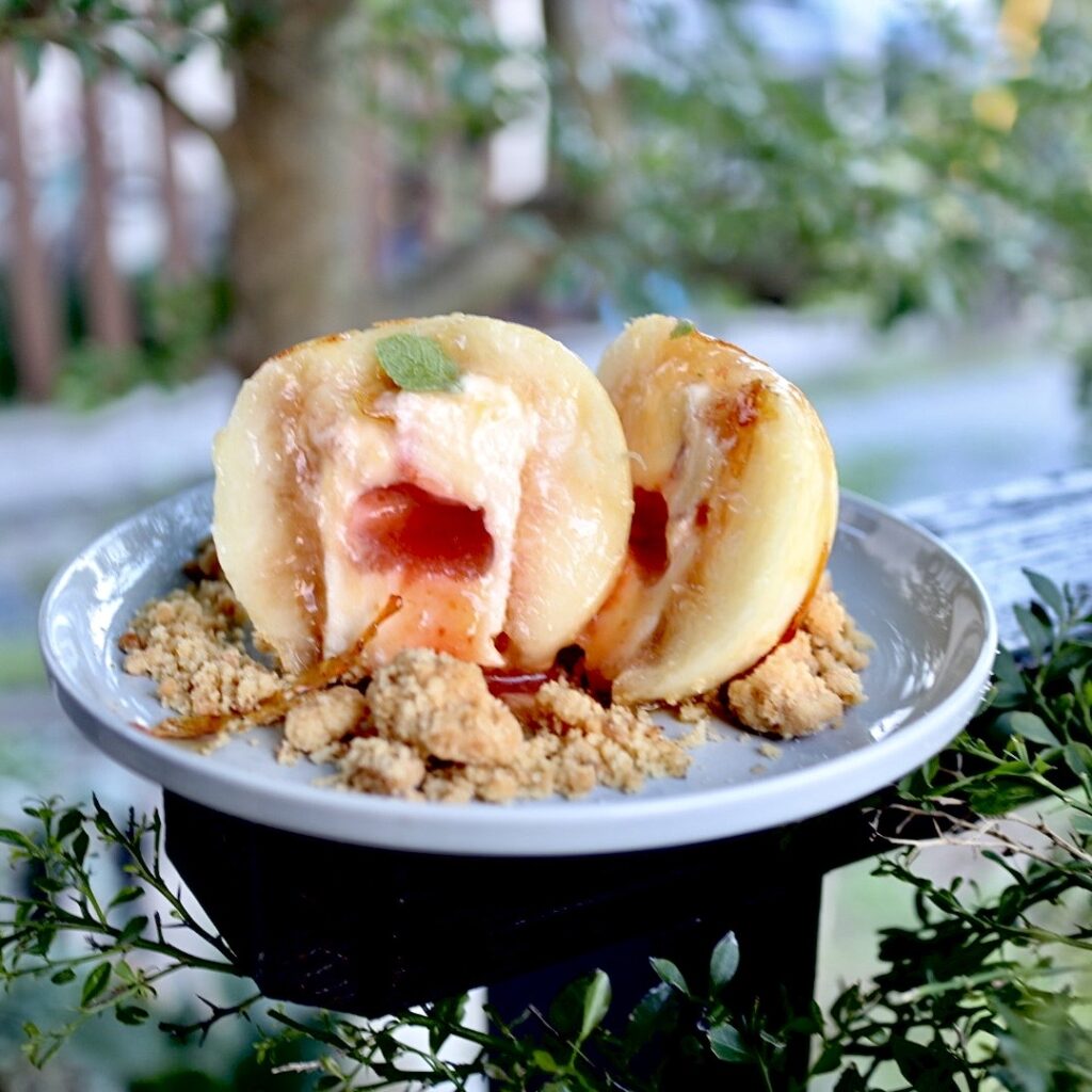 「丸ごと桃のブリュレケーキ」は、和歌山県産の生の桃を丸ごと採用し、表面をブリュレしたパリパリ食感が特徴のケーキ。中には濃厚でありながら軽い食感のバニラムースと甘酸っぱいすももソースが入っている。価格はドリンク付きで税込み1,500円。