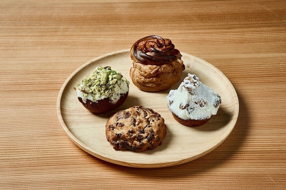 奥から時計回りに「明太グラタンシュー」、「ラムレーズンケーキ」、「チョコレートジャンキークッキー」、「リッチピスタチオケーキ」