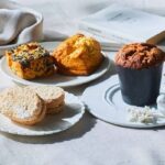 左手前から時計回りに「ドゥラメール（DE LA MER）」の「塩キャラメルバニラクリームのダックワーズ」1個・361円、「ごま塩と栗の豆乳スコーン」381円、「立地バターミルクスコーン」391円「スパイスクランブルのキャロットケーキ」582円