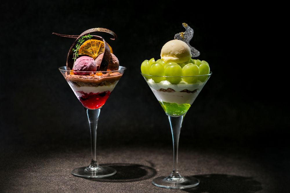 左から通年販売される「Chocolate Parfait ～ショコラ・ノワール～」税込み1,800円、期間限定で販売される「Seasonal Parfait ～シャインマスカット～」税込み2,500円（いずれもサービス料含む）
